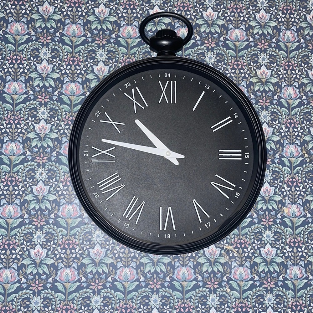 Black Roman numeral clock is functional